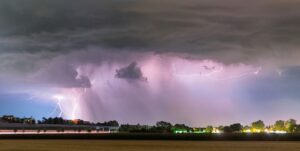lightning striking through dark storm clouds