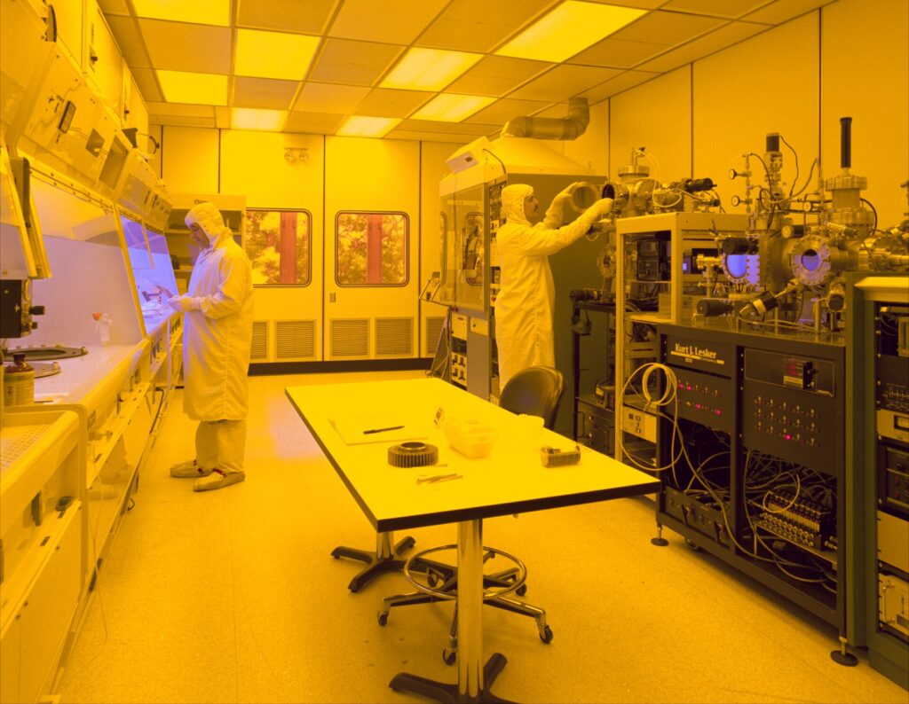 Semiconductor factory clean room with engineers producing computer chips